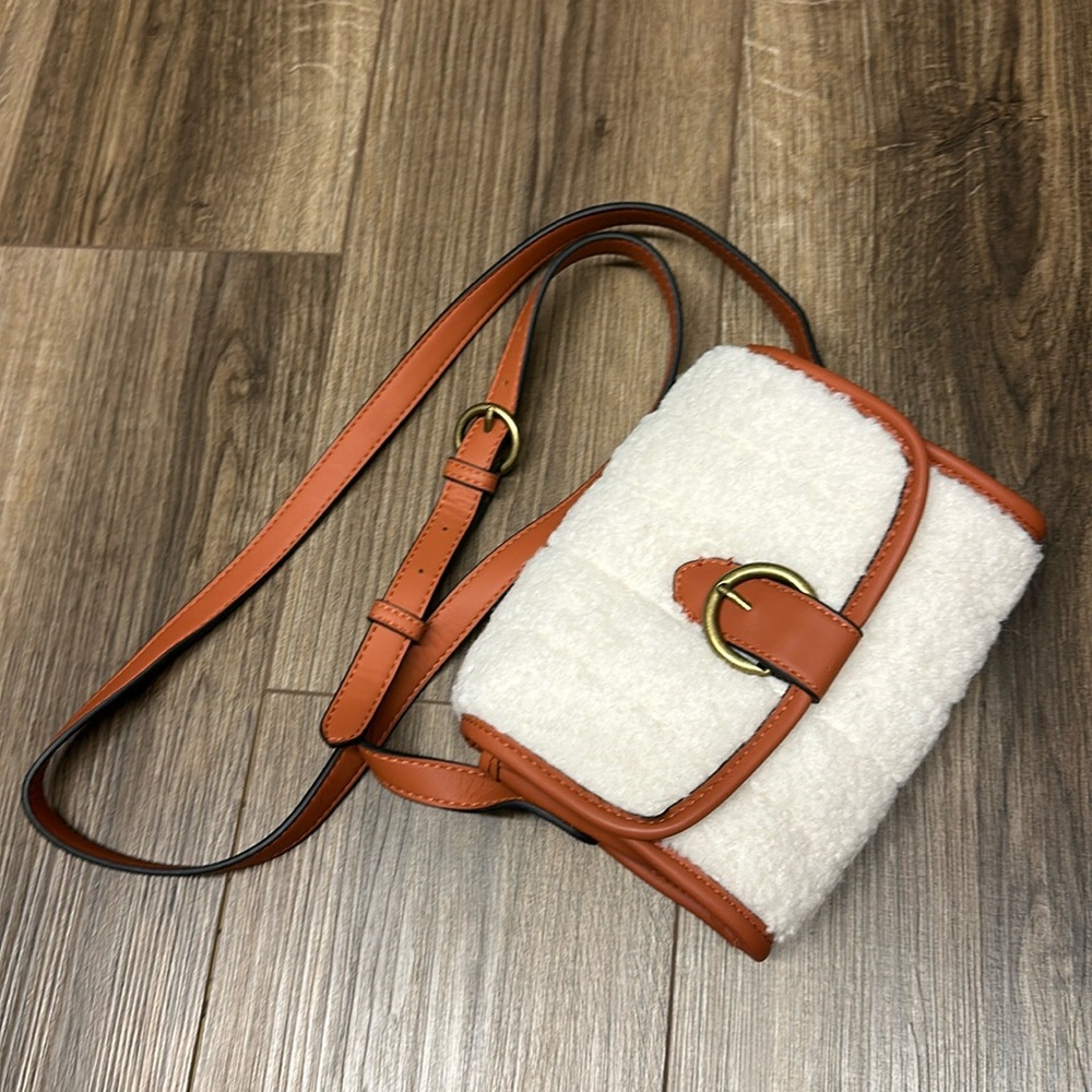 Small purse with a fuzzy material snap closure
